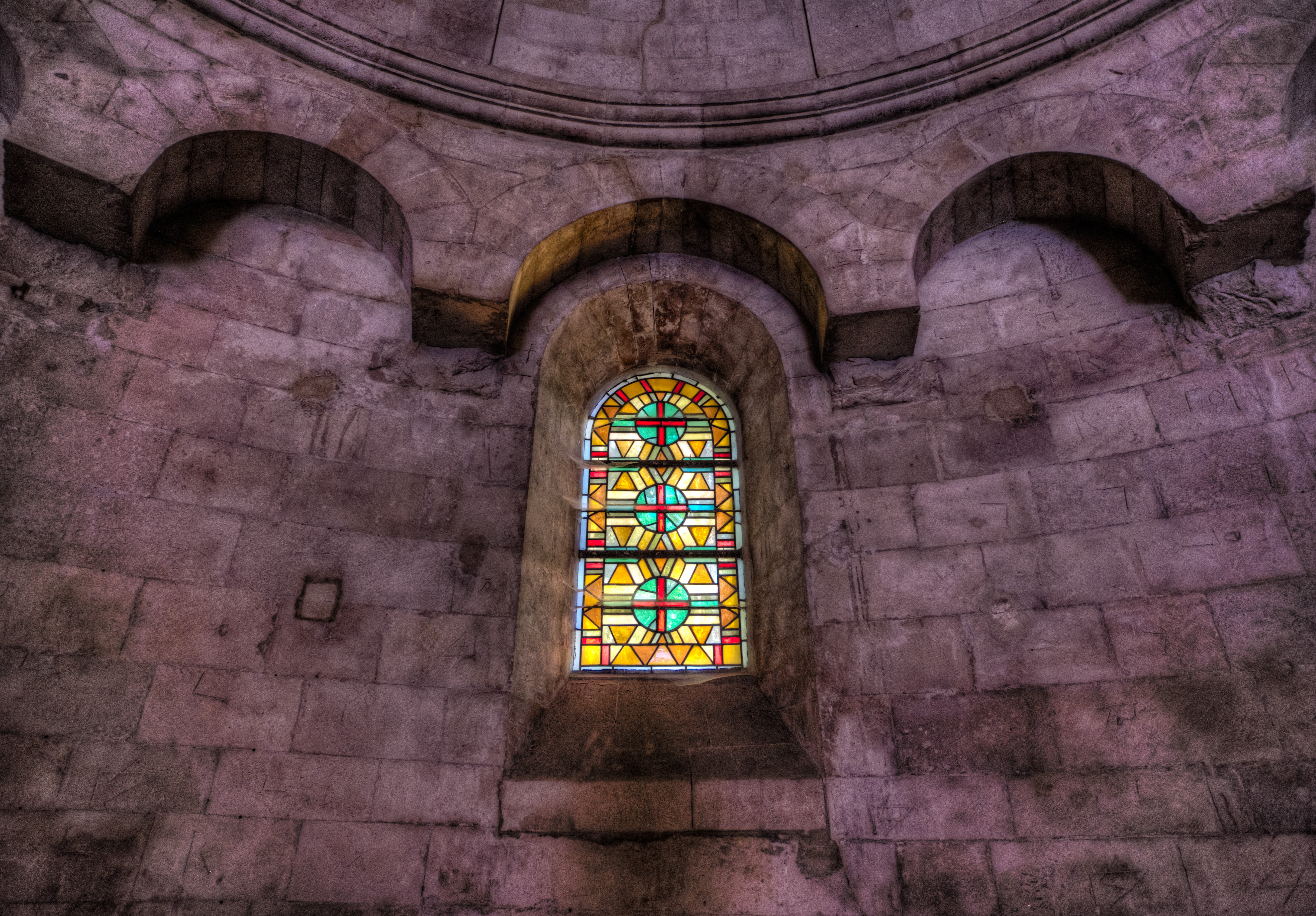 Stained glass window in a stone church HD Wallpaper