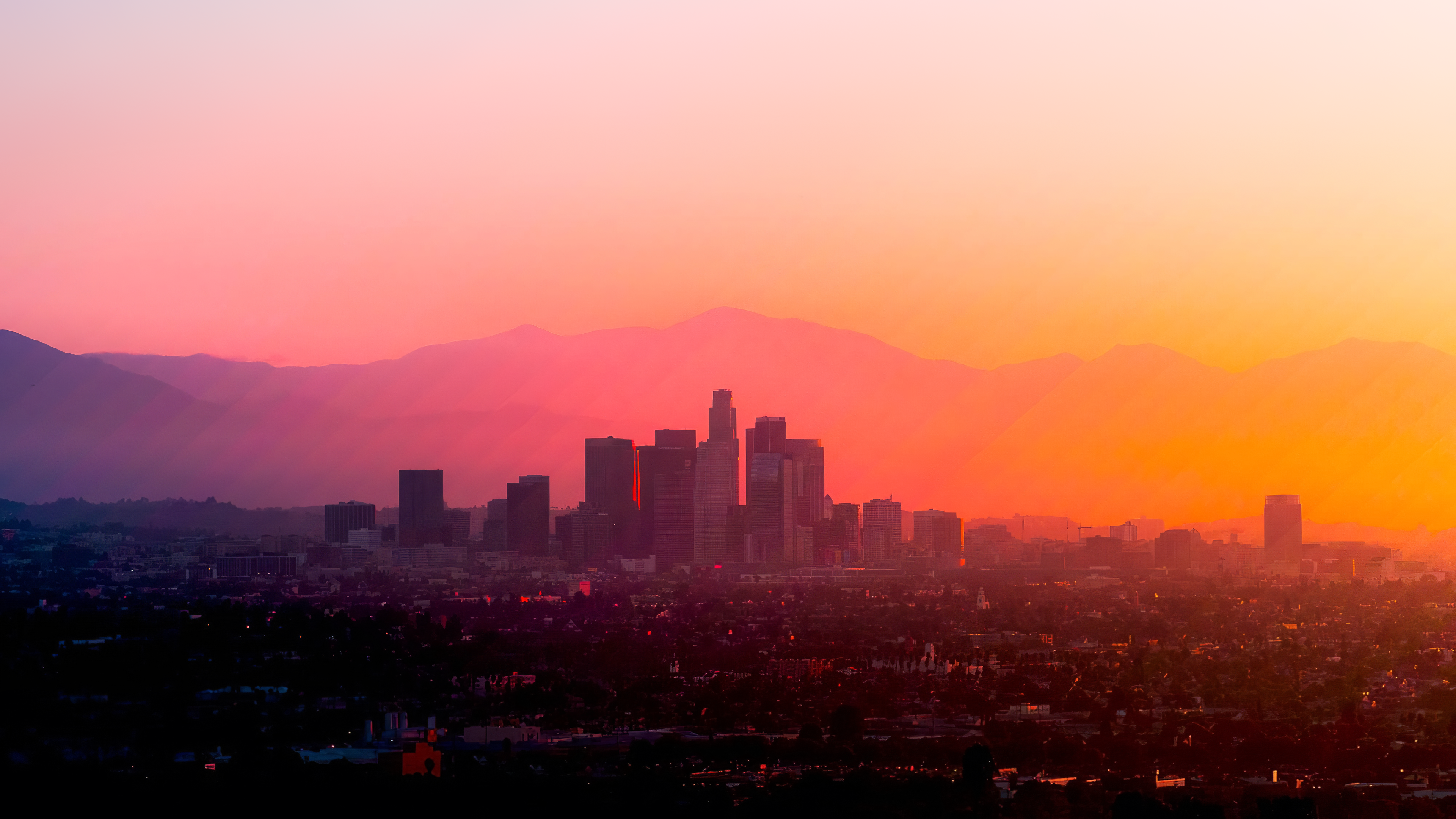 Los Angeles cityscape at sunset with mountains HD Wallpaper