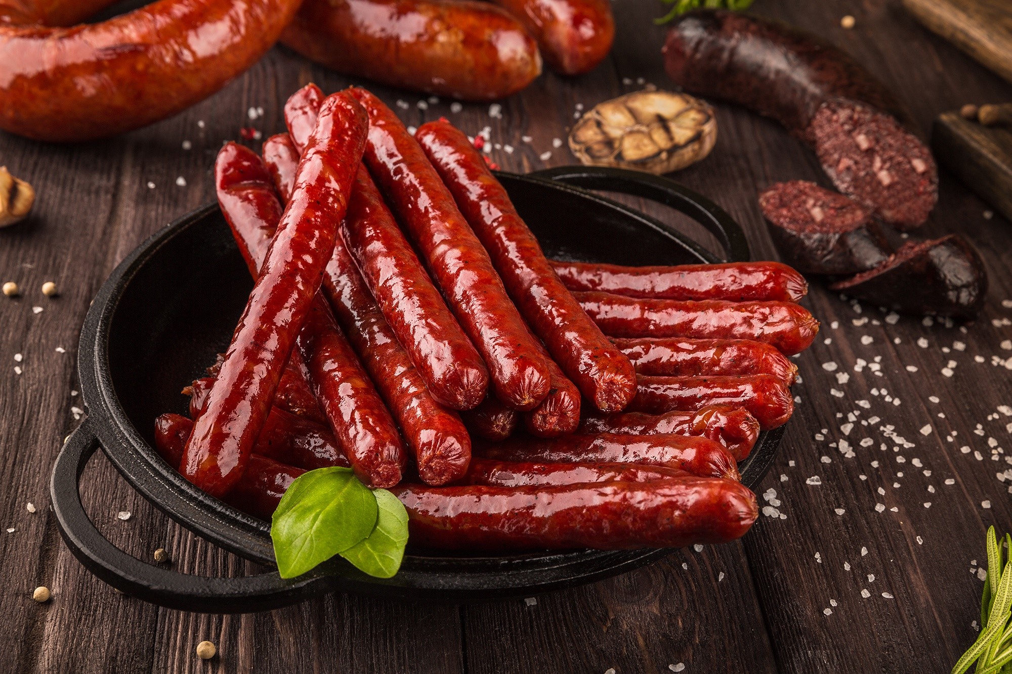 Sausages and blood sausage on a wooden table HD Wallpaper