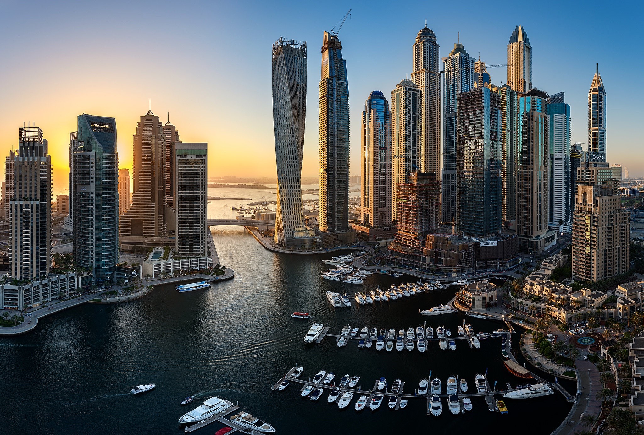 Dubai Marina cityscape with skyscrapers and boats at sunset HD Wallpaper