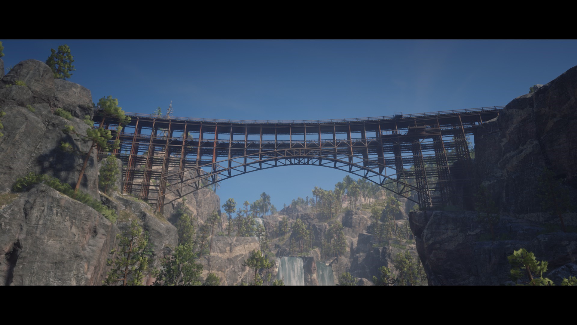 Bridge over a canyon with waterfall in Red Dead Redemption 2 HD Wallpaper