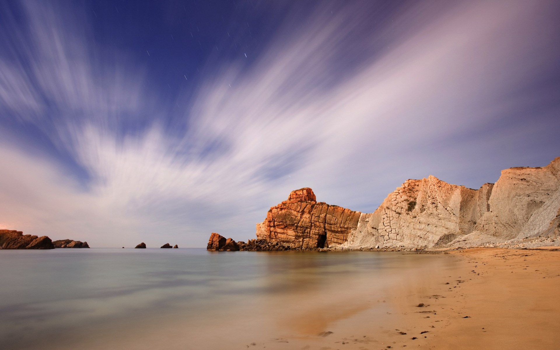 Long exposure of a rocky coastline at night HD Wallpaper