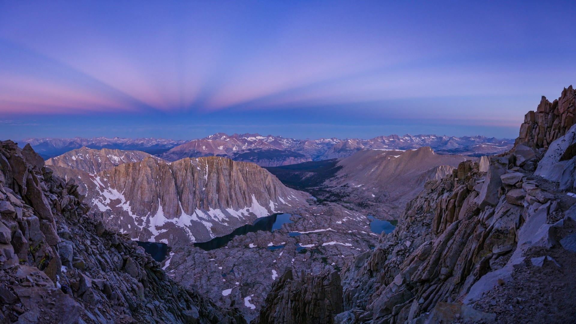 Mountain range with sun rays over lakes at dawn HD Wallpaper