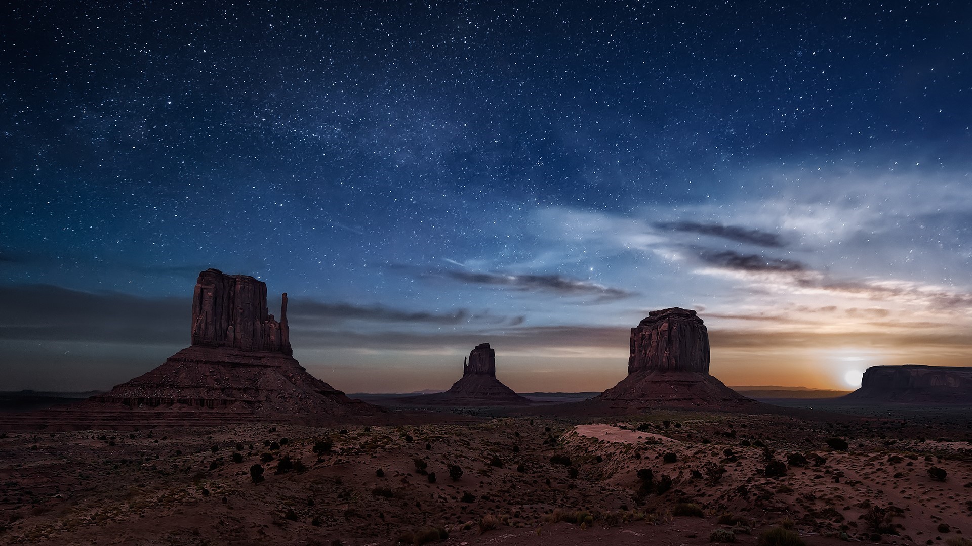 Monument Valley at night under a starry sky HD Wallpaper