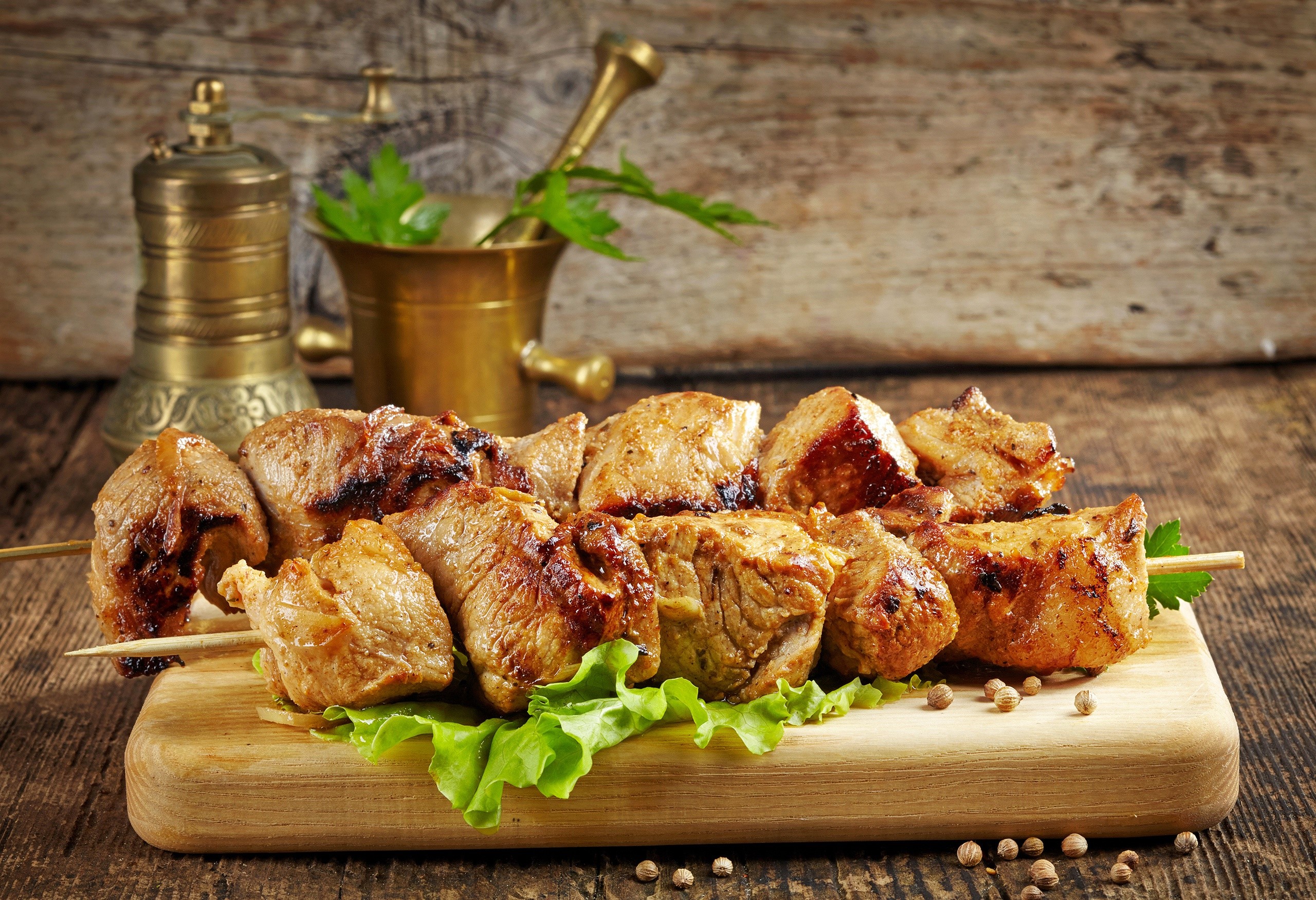 Grilled meat skewers on a wooden board with spices HD Wallpaper