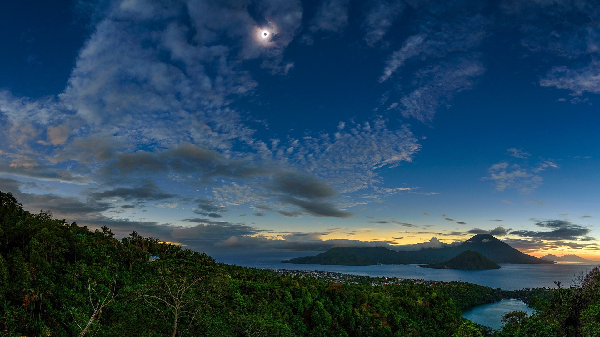 Solar eclipse over islands and mountains at sunset HD Wallpaper
