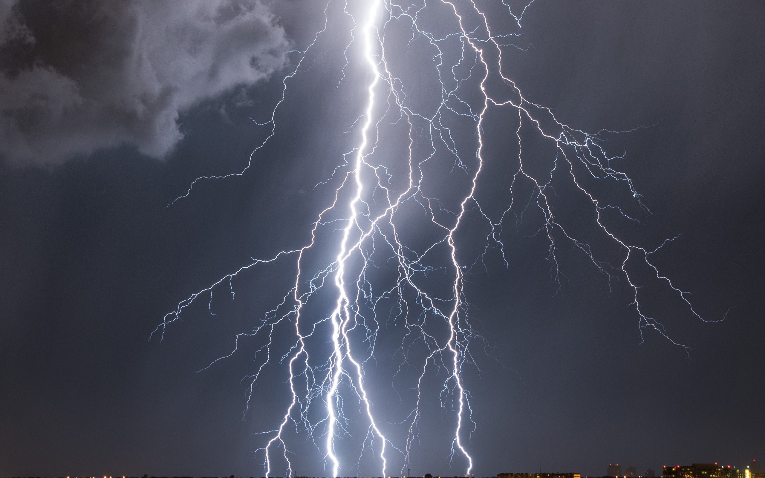 Lightning strikes over a city at night HD Wallpaper