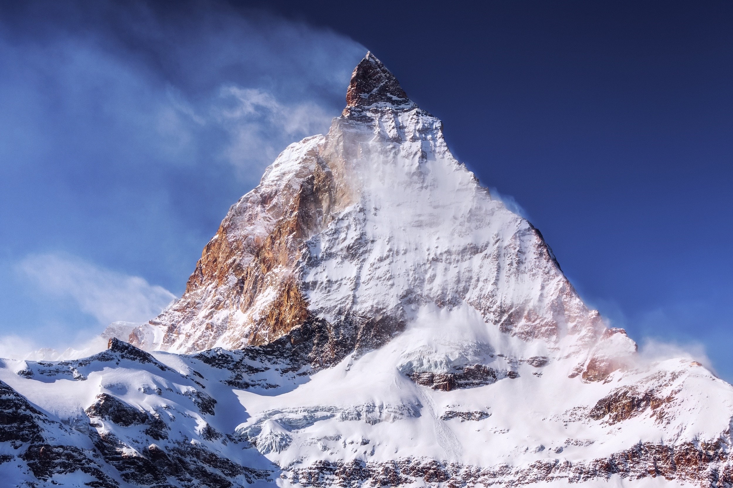 Snow-covered Matterhorn mountain peak under a blue sky HD Wallpaper