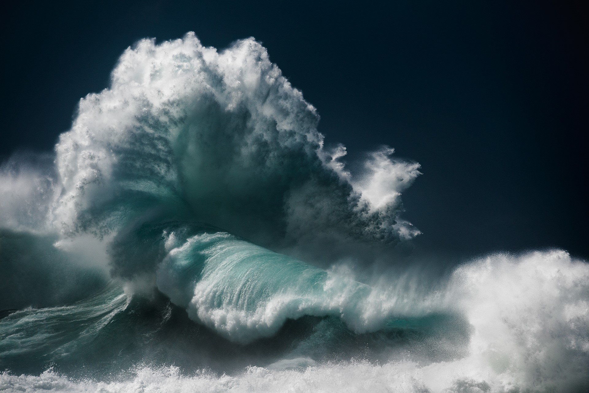 Massive wave crashing with white foam against dark blue sky HD Wallpaper