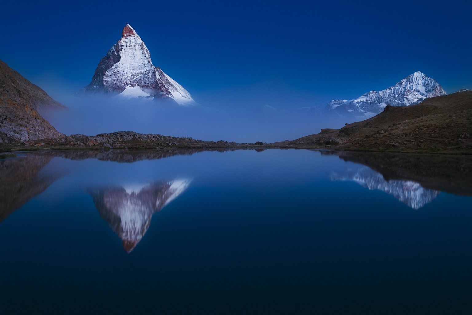 Matterhorn reflected in a lake with mist HD Wallpaper