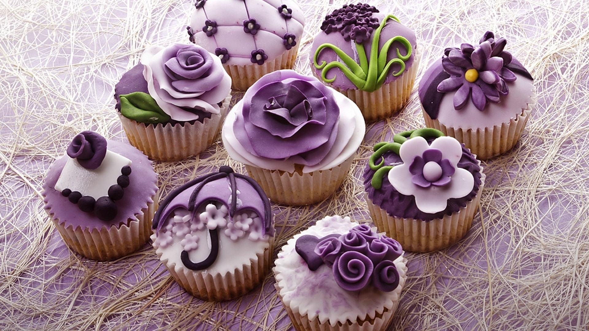 Purple and white decorated cupcakes on a textured surface HD Wallpaper