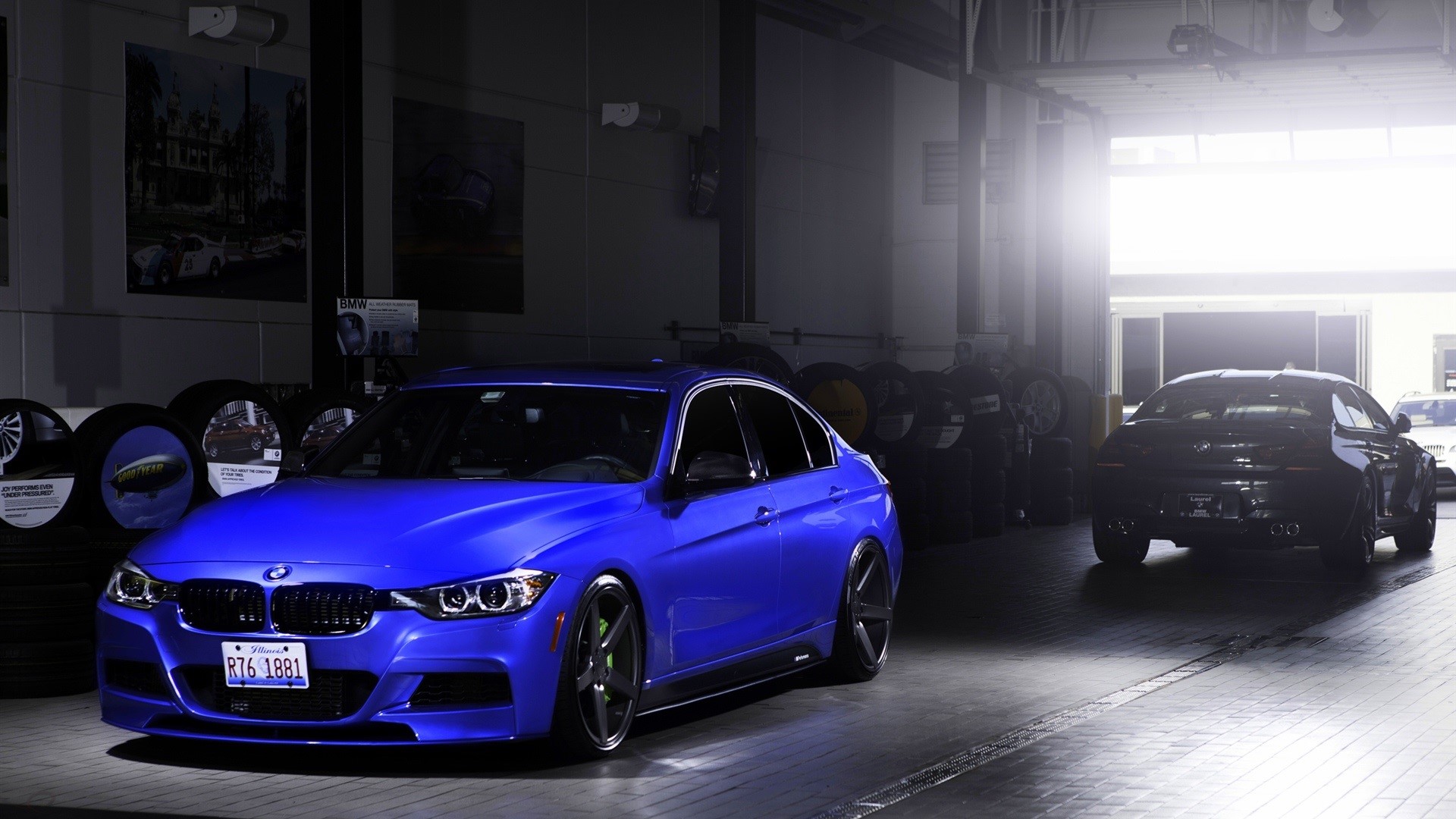 Blue BMW 3 Series and black Porsche in a garage HD Wallpaper