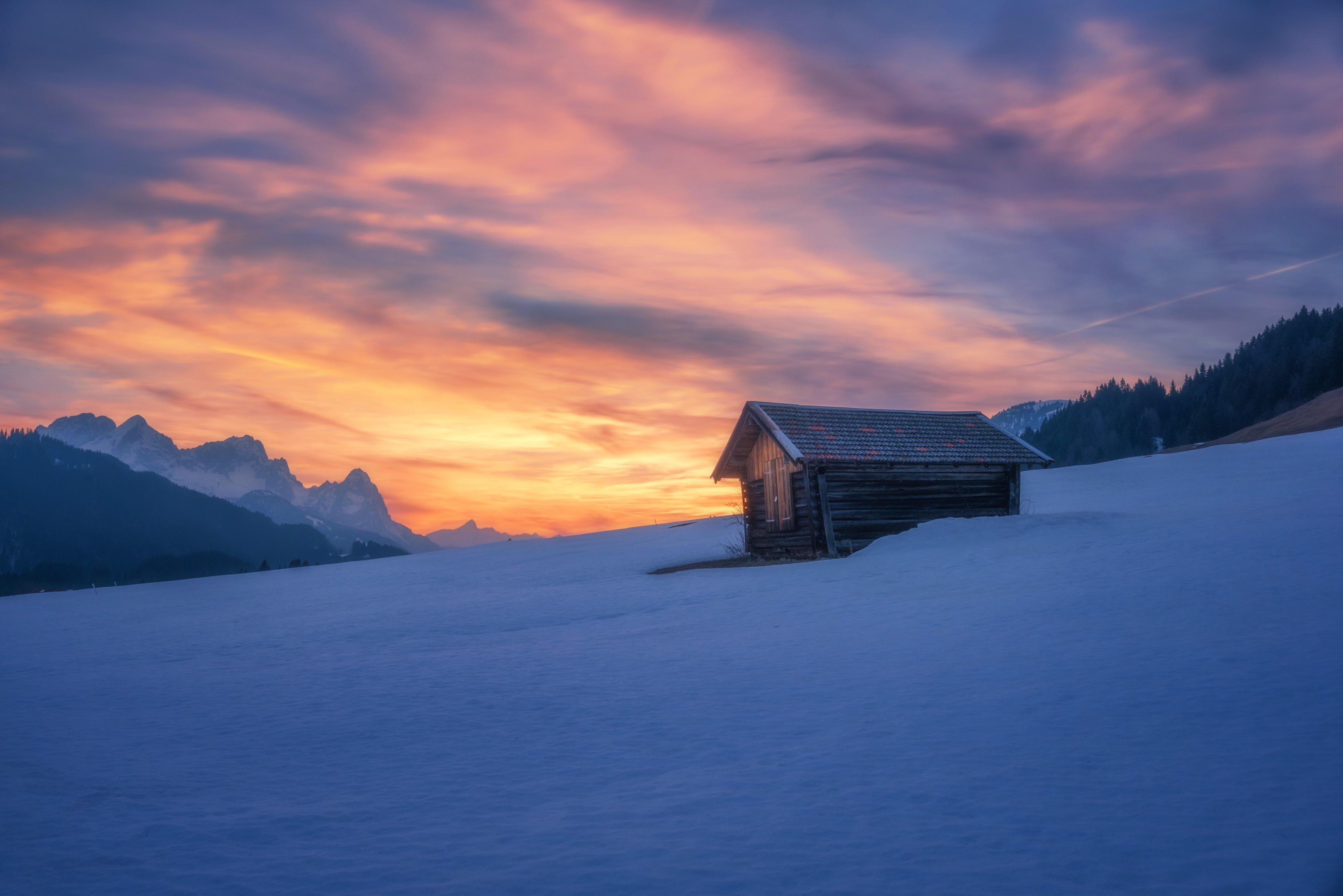 Wooden cabin in snowy landscape at sunset HD Wallpaper