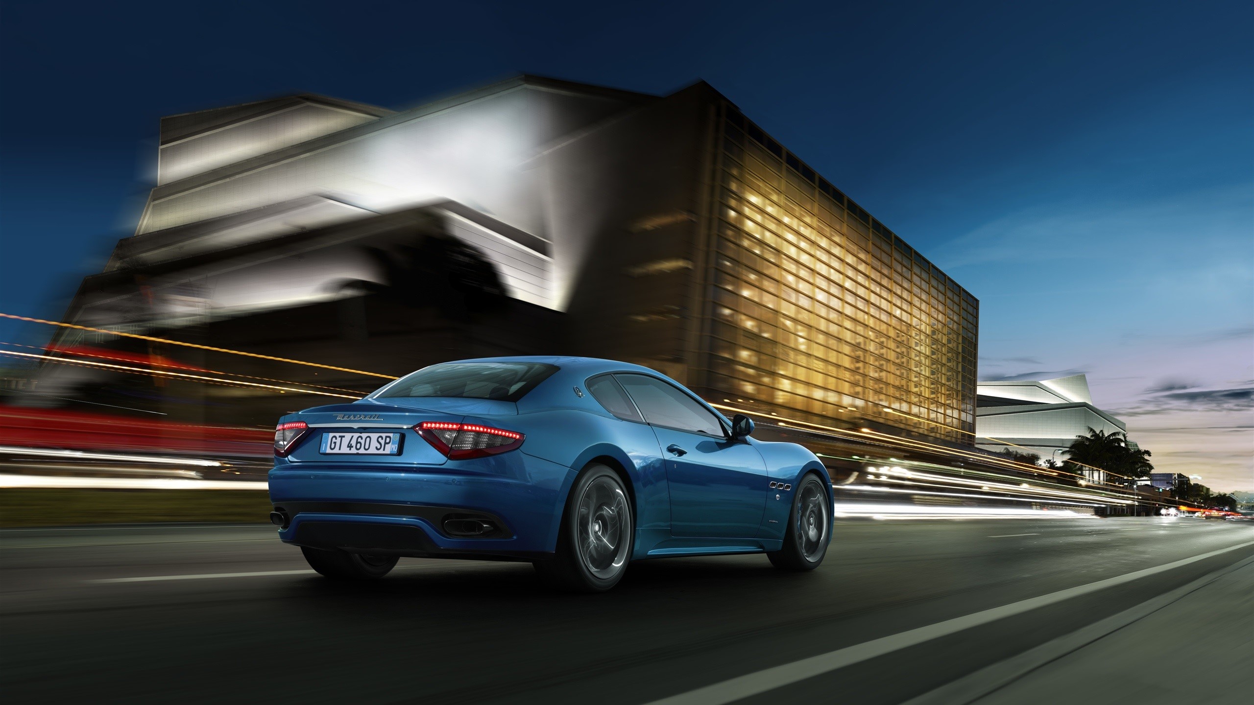 Blue Maserati GranTurismo driving on a road at night HD Wallpaper