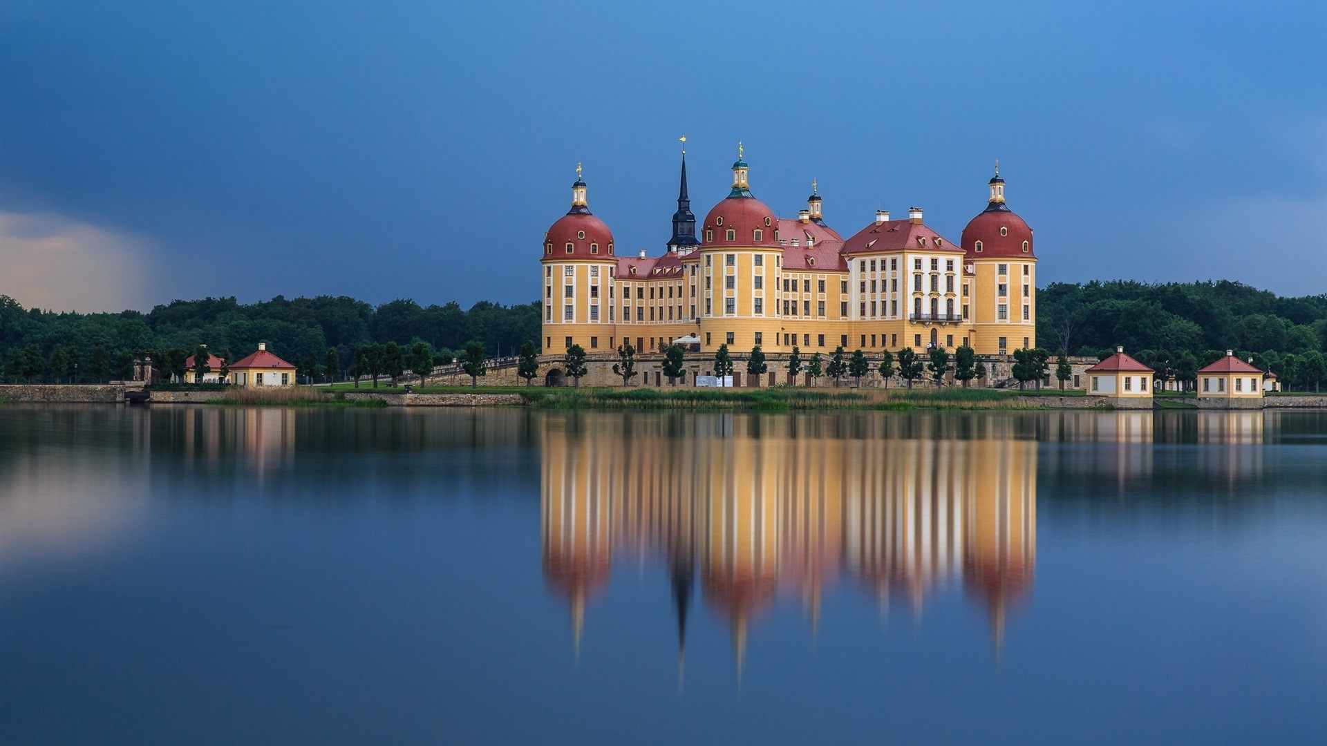 Moritzburg Castle reflected in a lake under a stormy sky HD Wallpaper
