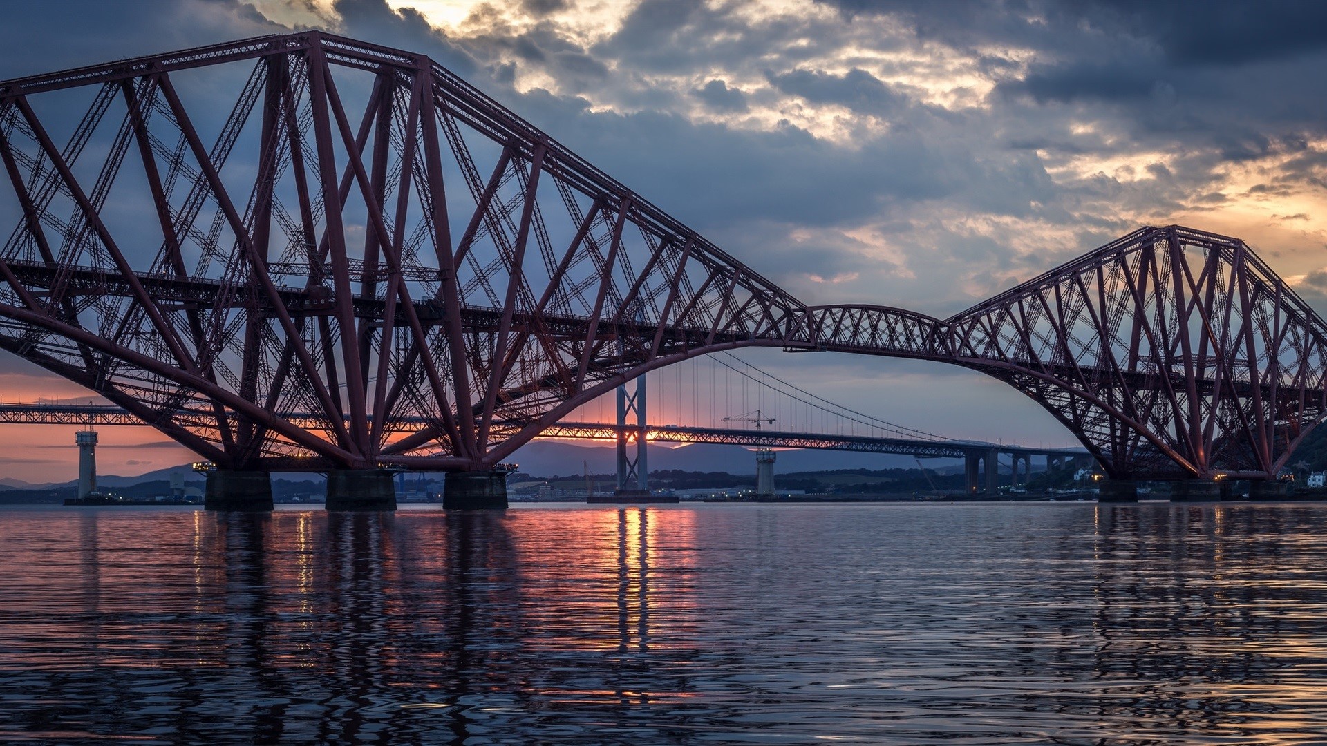 Forth Bridge at sunset with reflections on water HD Wallpaper