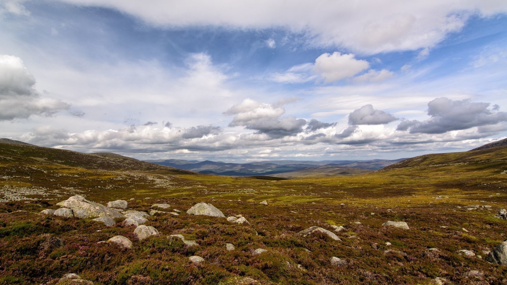 Hills and clouds over a rocky moorland landscape HD Wallpaper