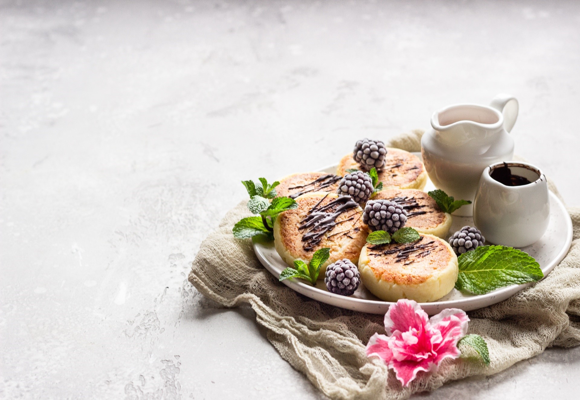 Syrniki with berries and chocolate drizzle HD Wallpaper