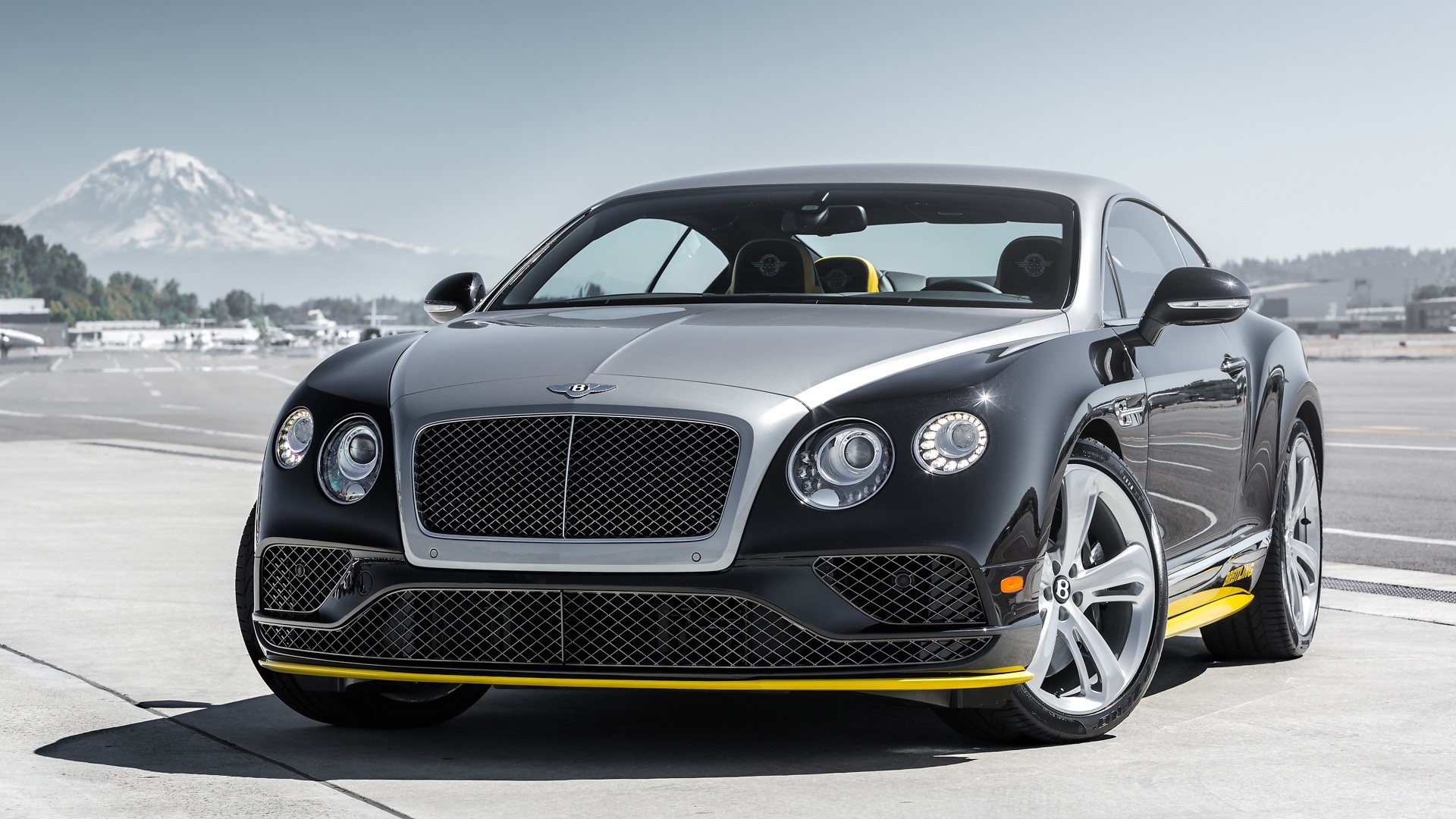 Bentley Continental GT on an airfield with a mountain HD Wallpaper