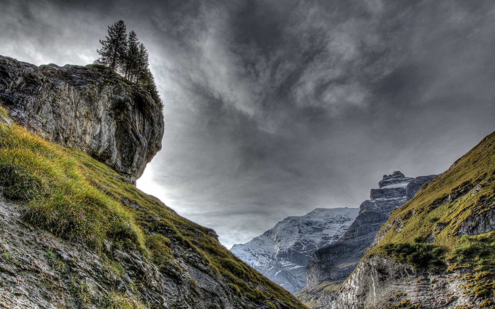 Dramatic mountain landscape with rocky cliffs and cloudy sky HD Wallpaper
