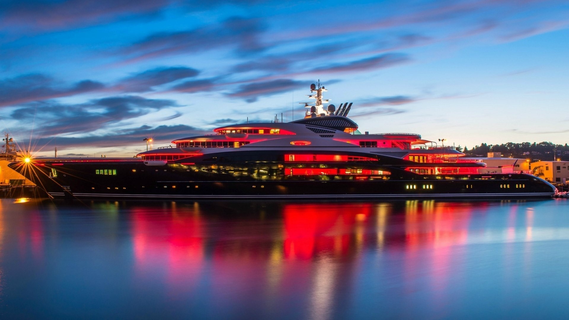 Luxury yacht illuminated with red lights at dusk HD Wallpaper