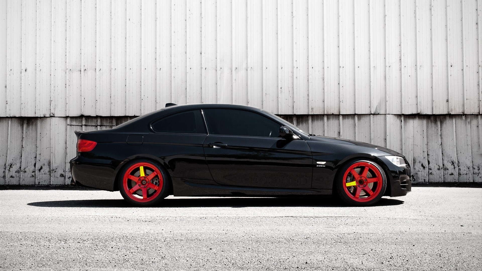Black BMW E92 coupe with red wheels on asphalt HD Wallpaper