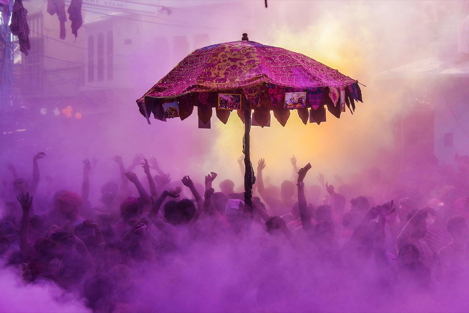 Holi festival celebration with colorful powder and an umbrella HD Wallpaper