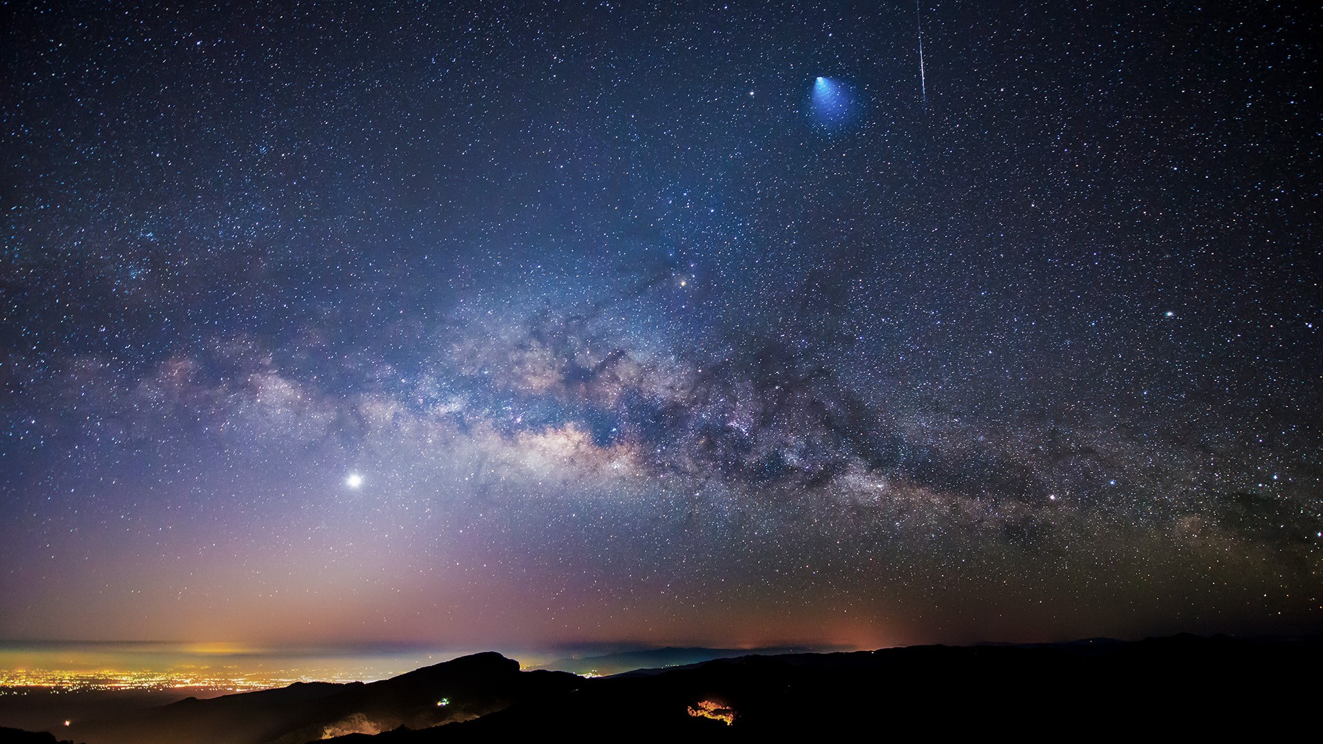 Milky Way and meteor shower over a city at night HD Wallpaper