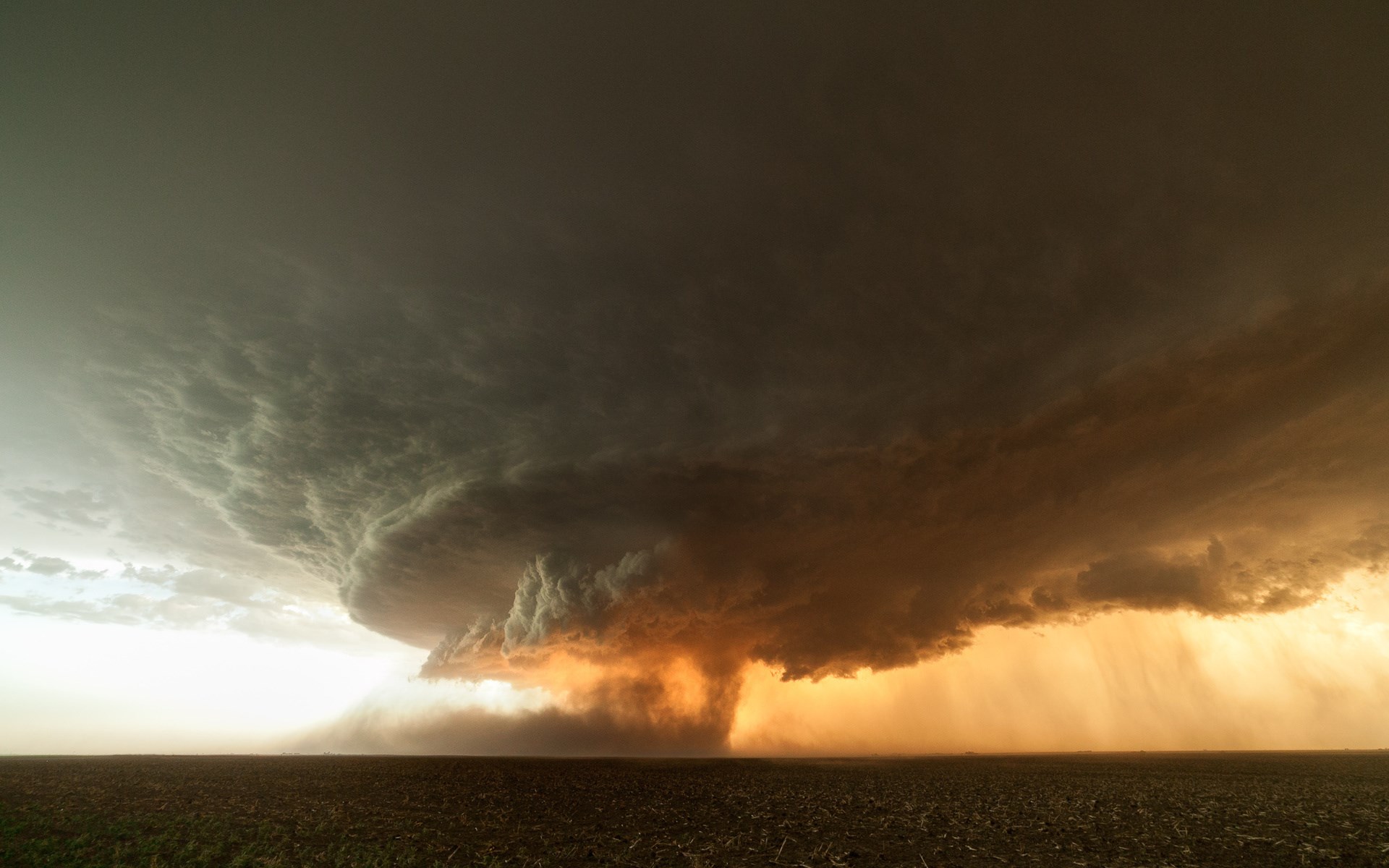Tornado forming over a field HD Wallpaper