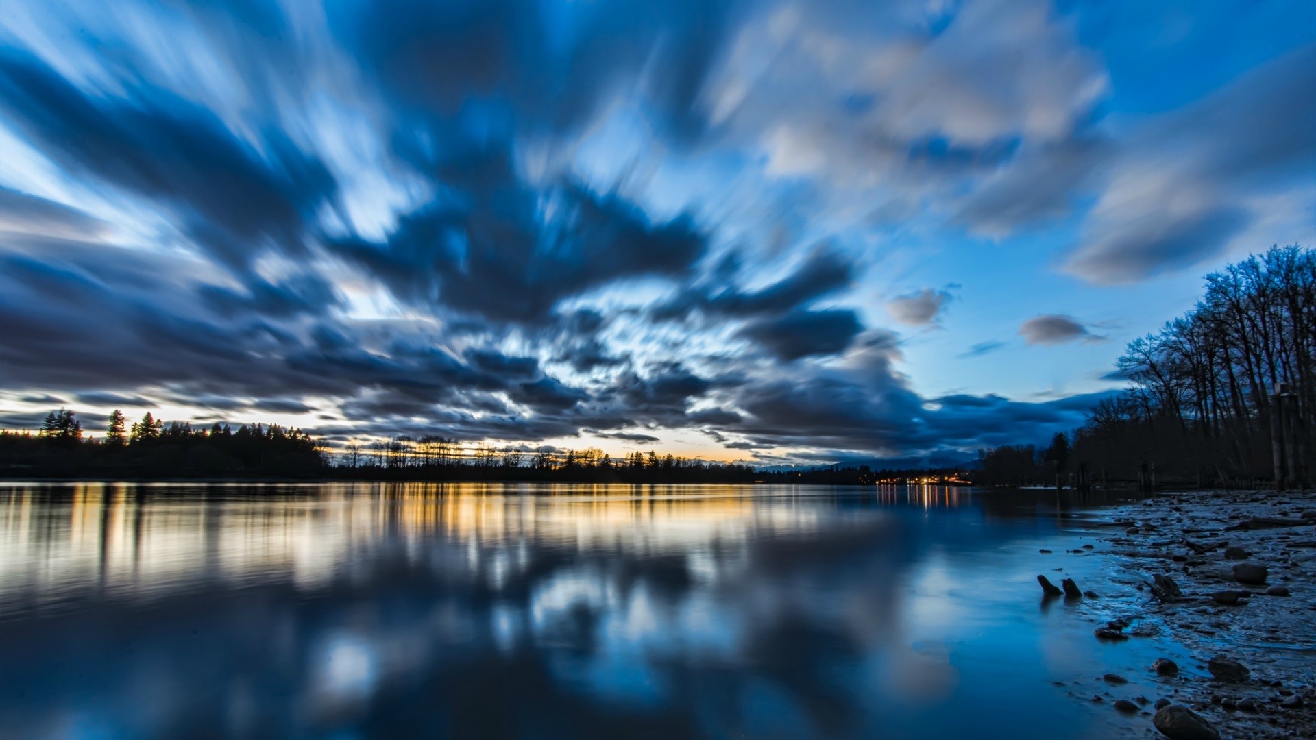 Long exposure of clouds over a lake at dusk HD Wallpaper