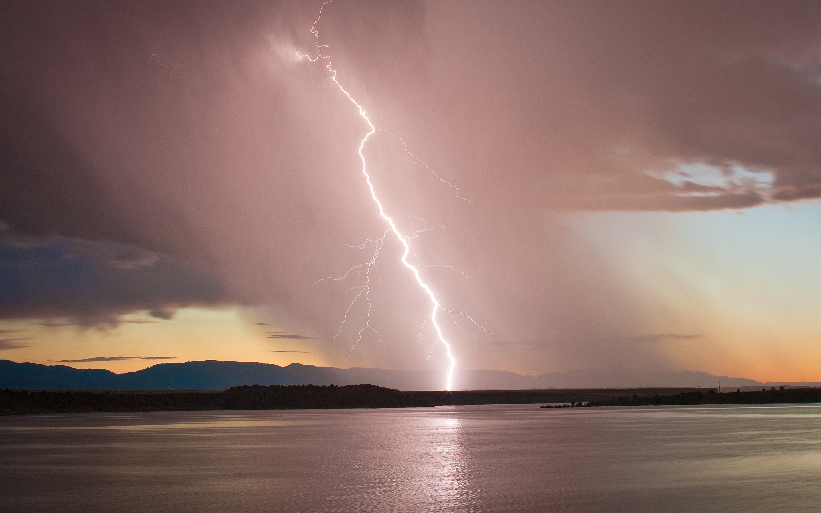 Lightning strike over a lake at sunset HD Wallpaper