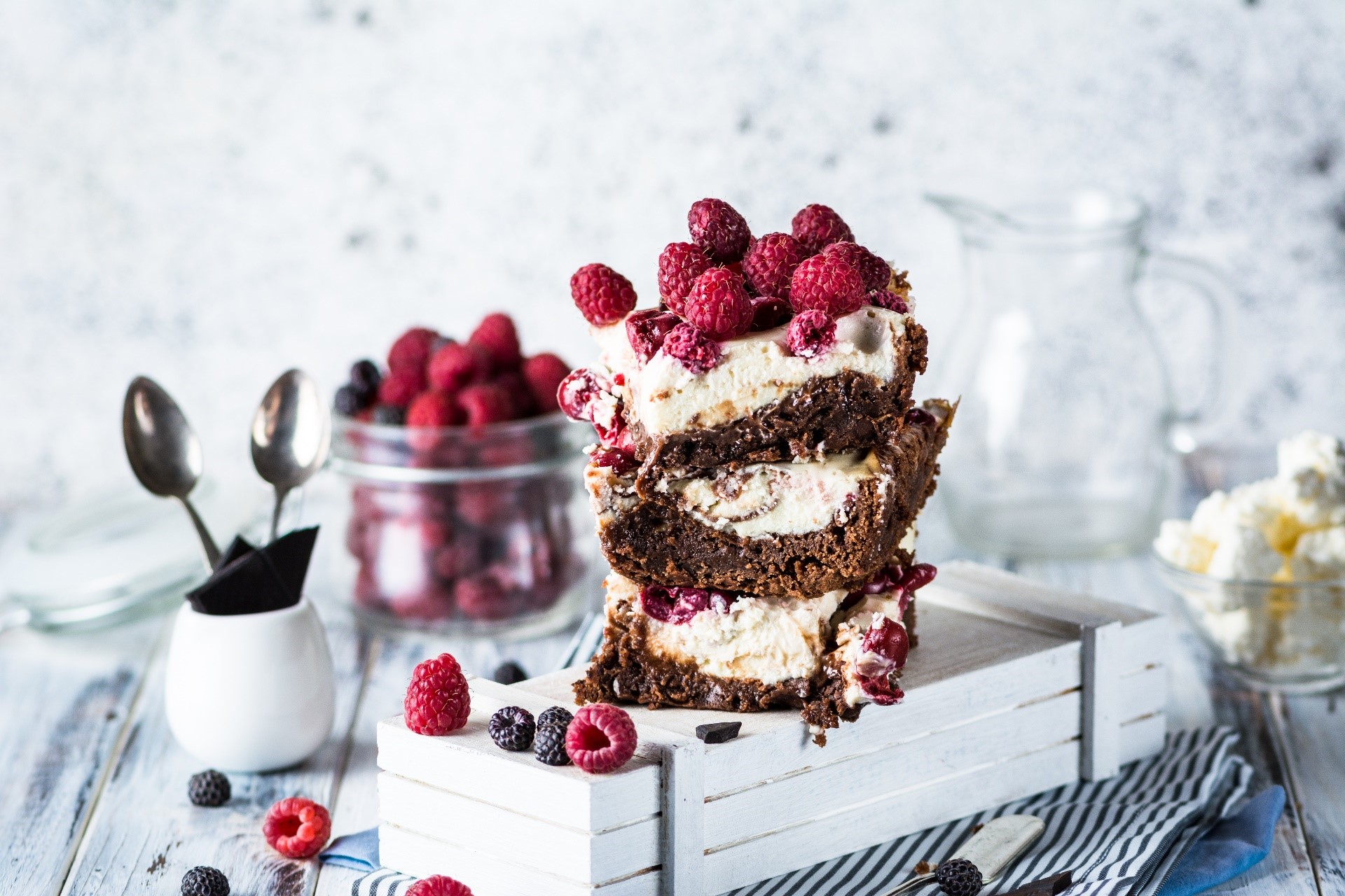 Stack of chocolate raspberry cake slices with fresh berries HD Wallpaper