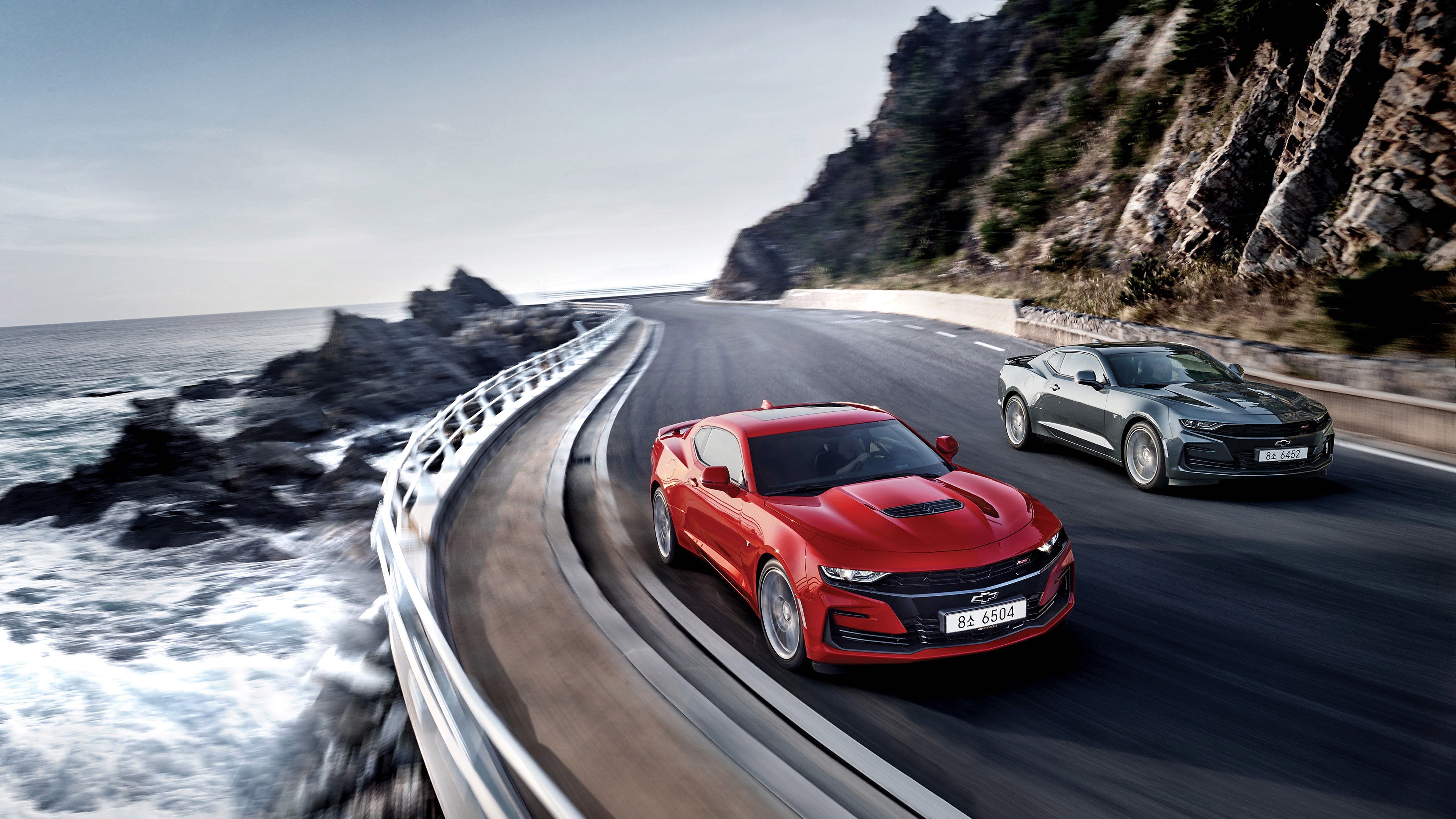 4K Chevrolet Camaro SS cars on coastal road HD Wallpaper