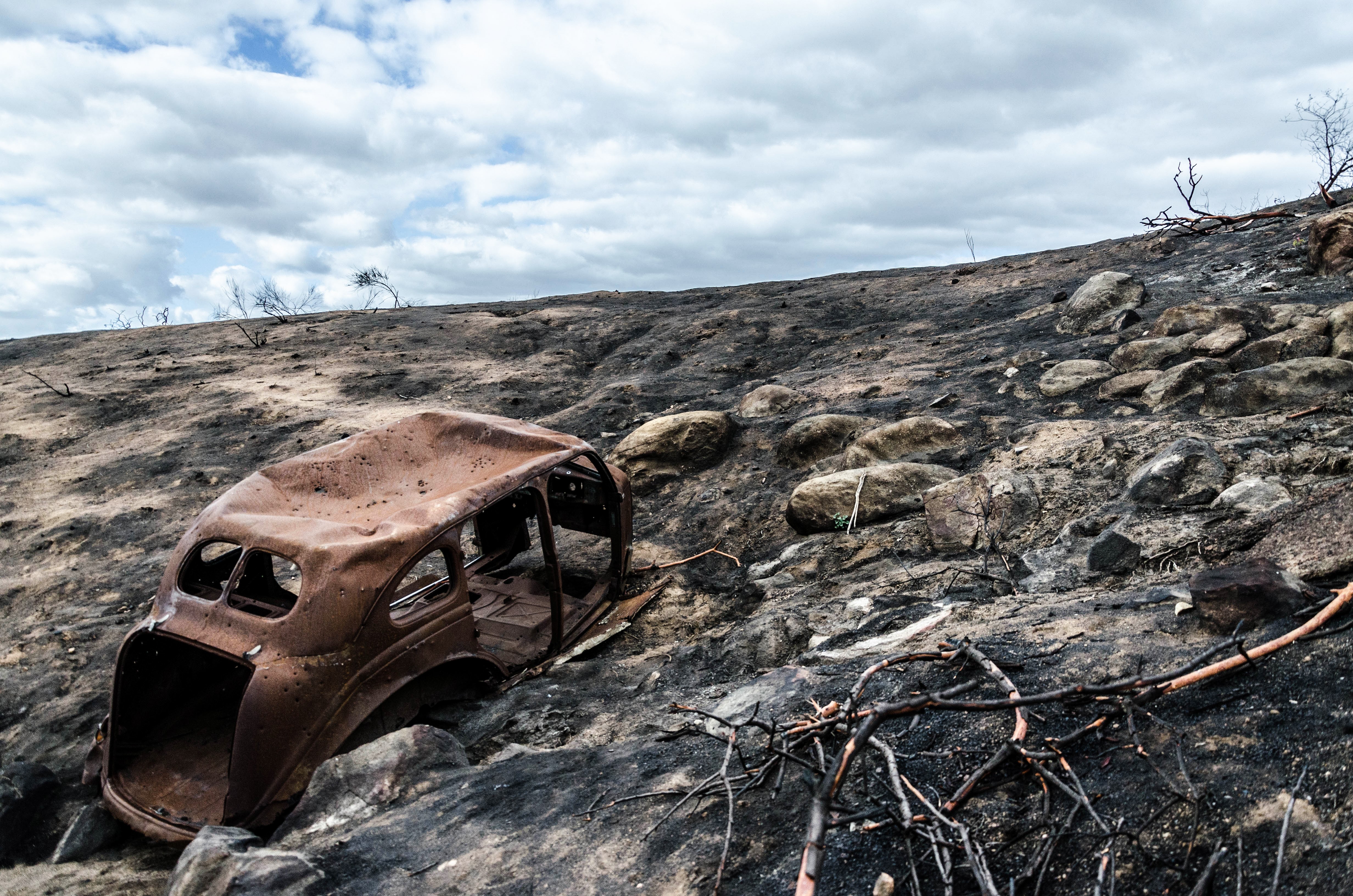 Burned car in San Diego landscape HD Wallpaper