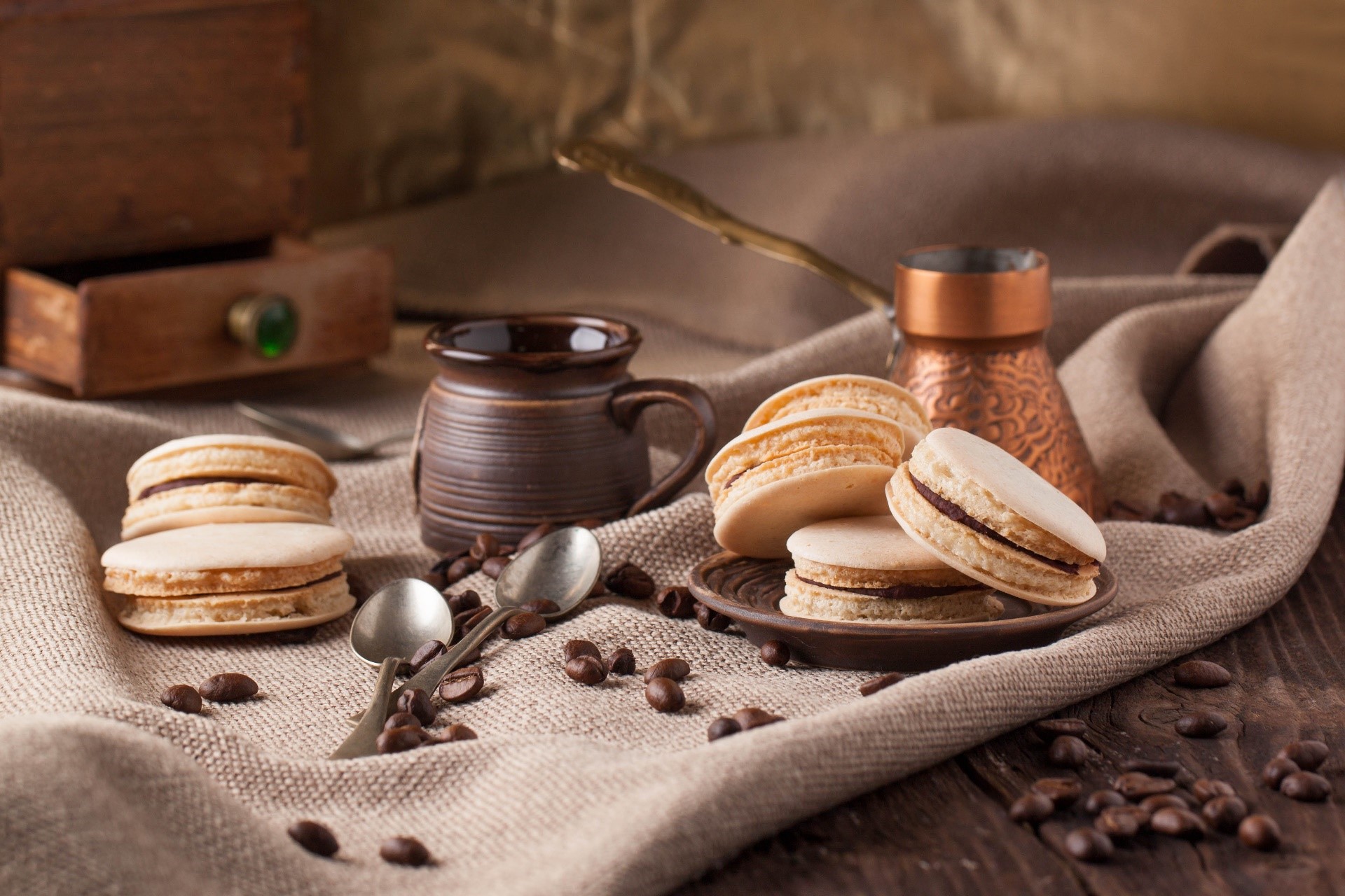 Macarons and coffee beans on a wooden table HD Wallpaper