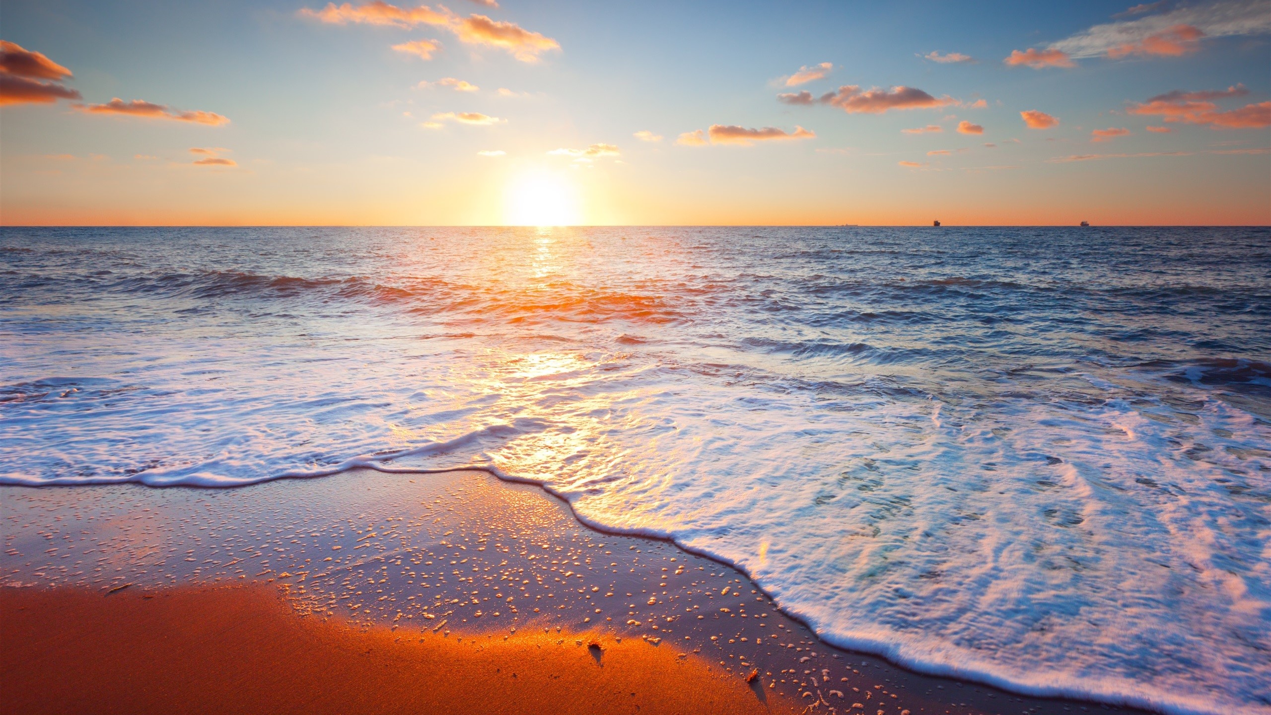 Sunset over the ocean with waves on the beach HD Wallpaper