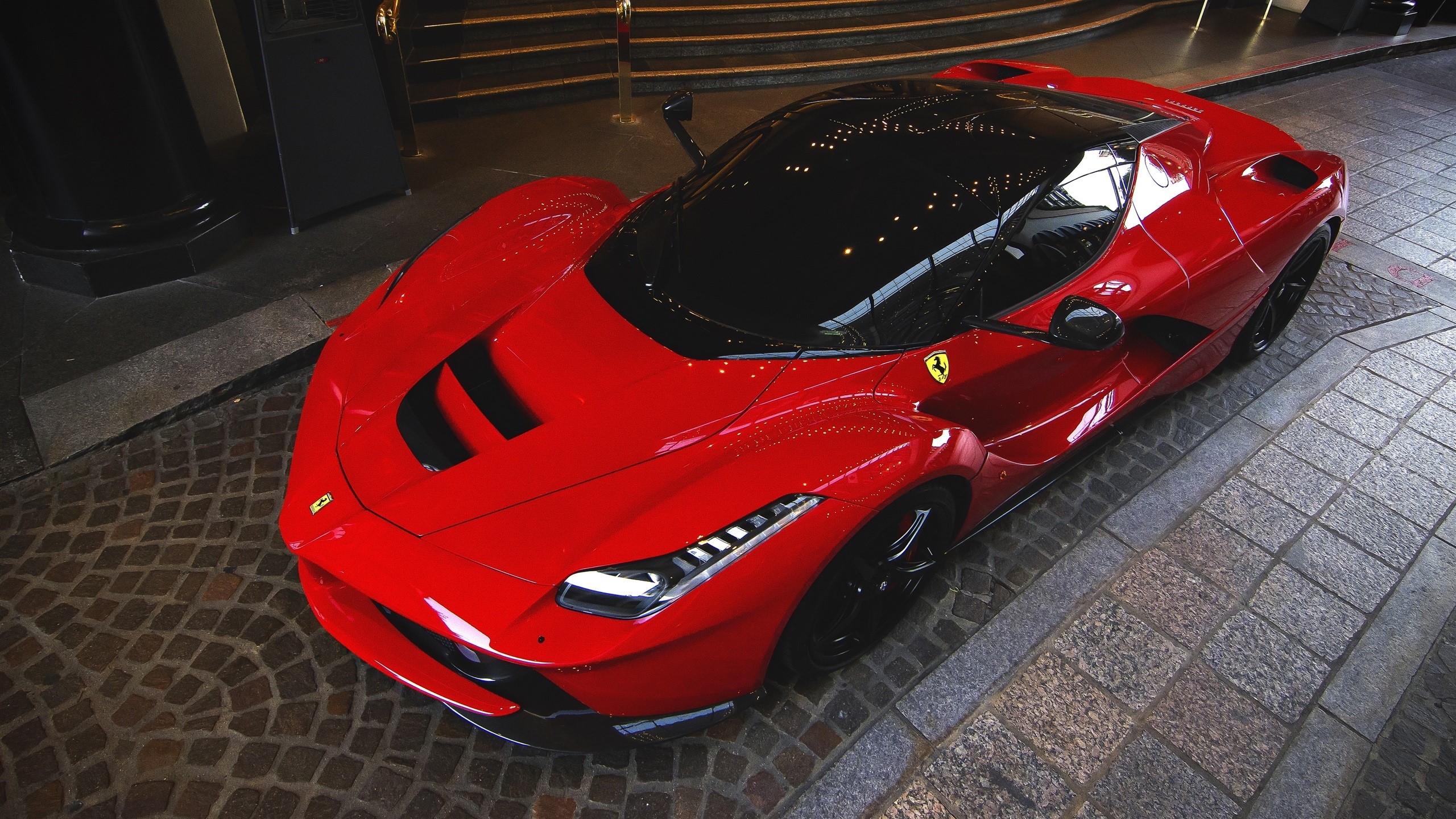 Red Ferrari LaFerrari parked on cobblestone street HD Wallpaper