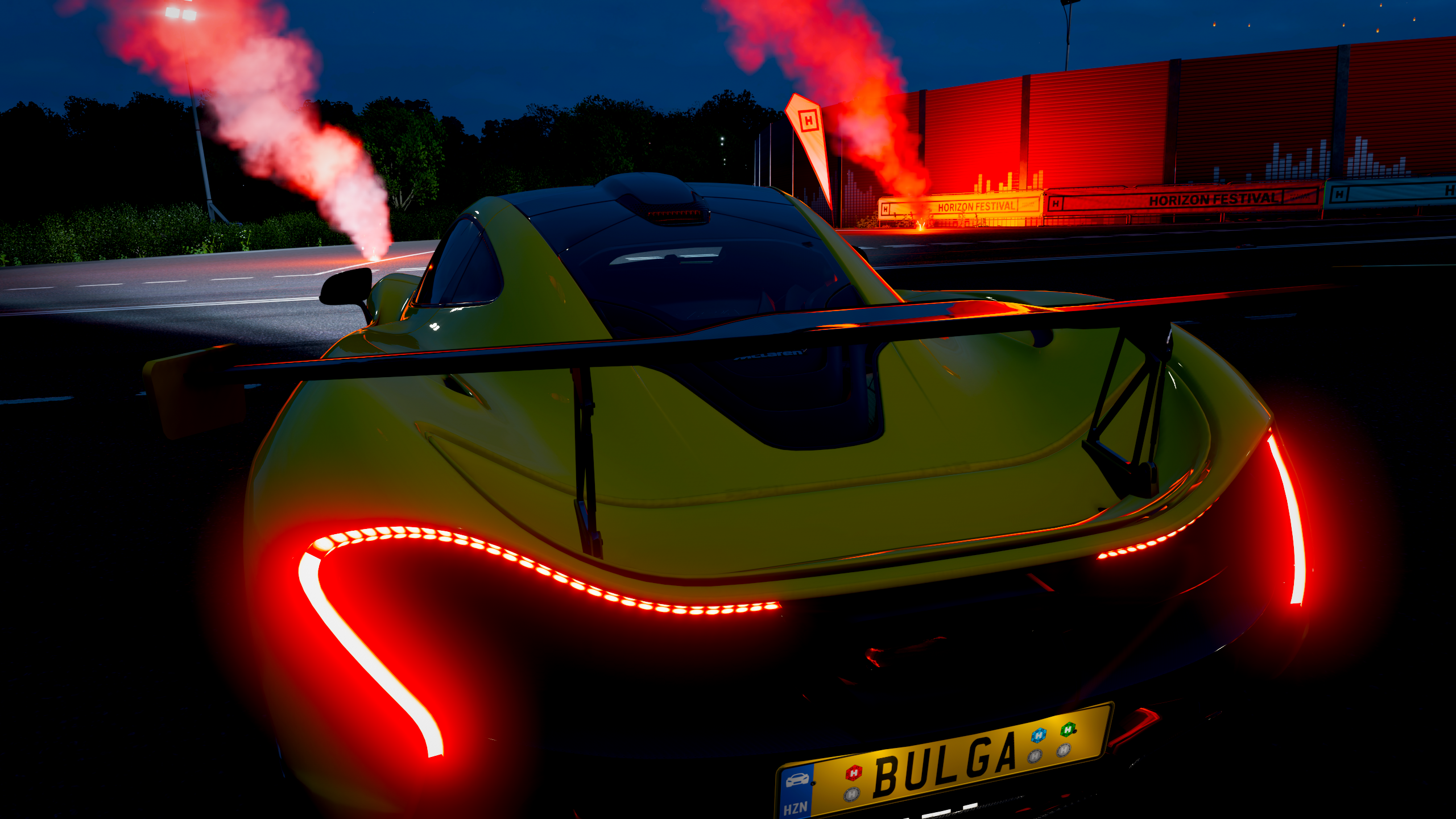 Yellow McLaren P1 with red smoke at Horizon Festival HD Wallpaper