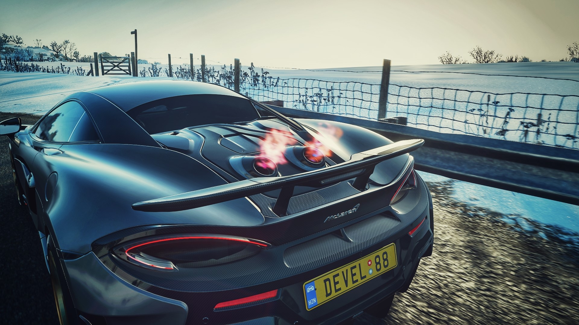 McLaren 600LT with flames in winter landscape HD Wallpaper