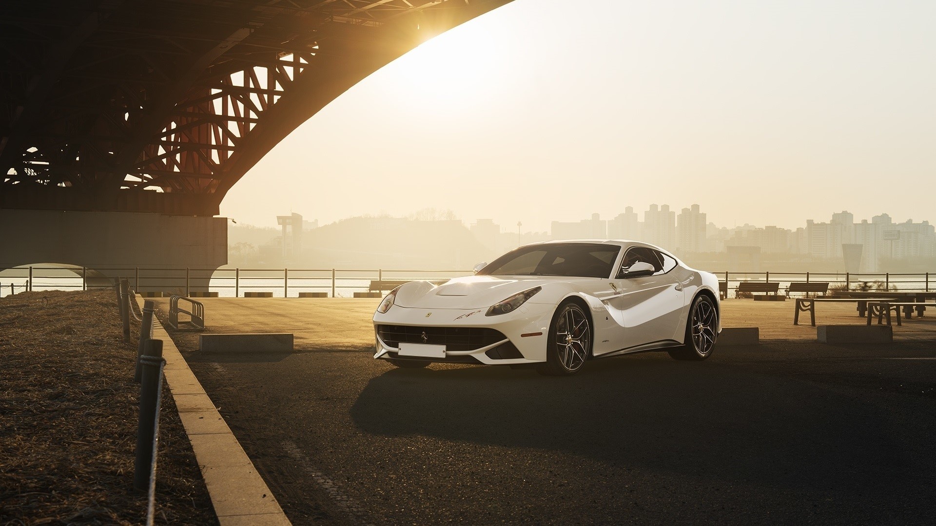 White Ferrari F12berlinetta parked under a bridge at sunset HD Wallpaper