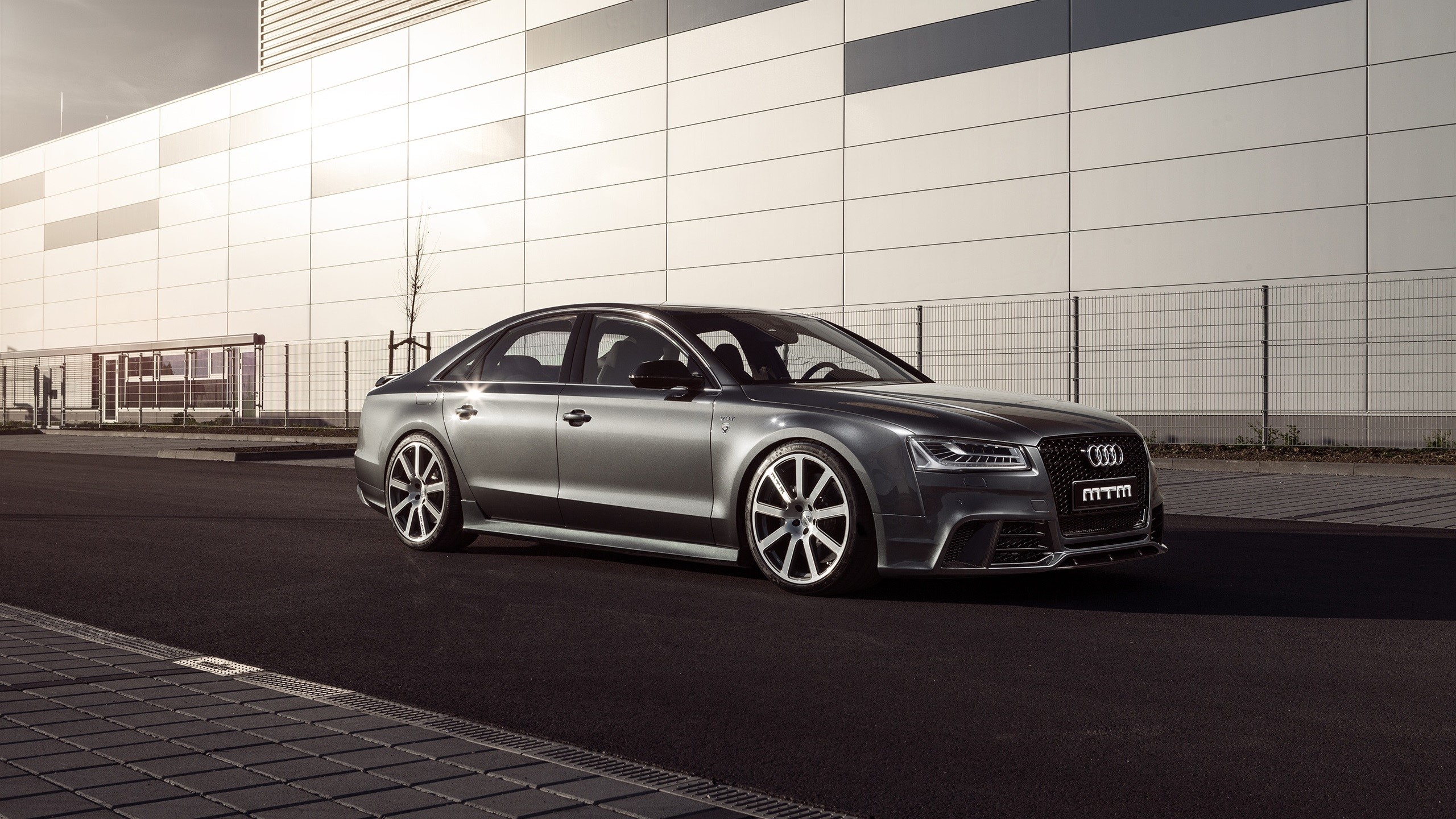 Silver Audi S8 MTM parked in front of a modern building HD Wallpaper