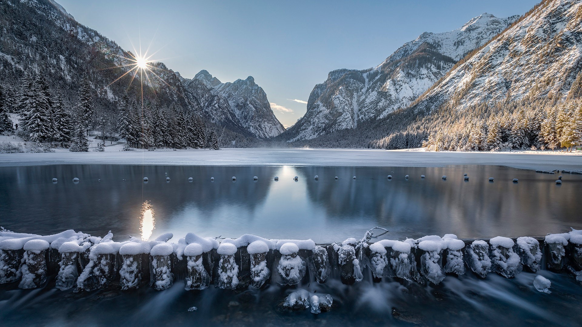 Winter sunrise over a frozen lake and snow-covered mountains HD Wallpaper