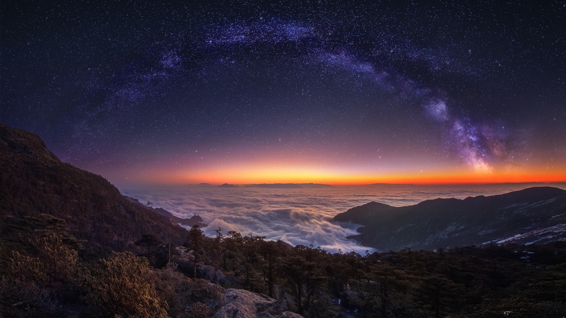 Milky Way over mountains and clouds at dawn HD Wallpaper