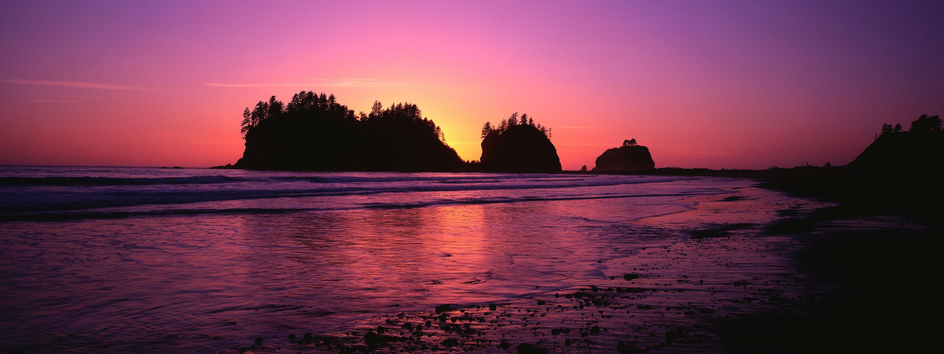 Sunset over a rocky coastline with islands HD Wallpaper