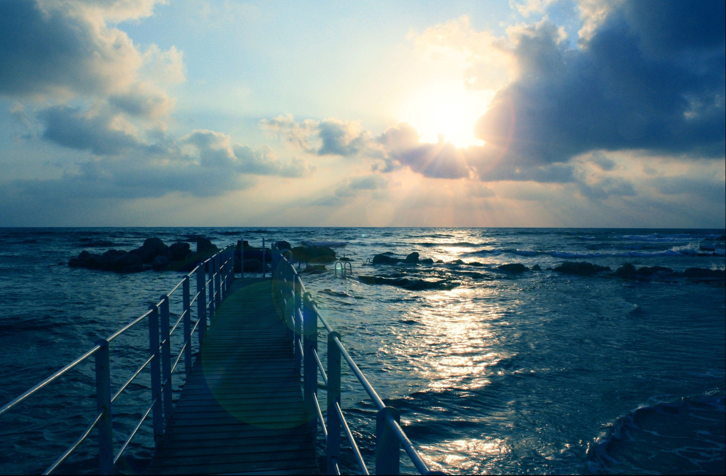 Pier over the ocean at sunset HD Wallpaper