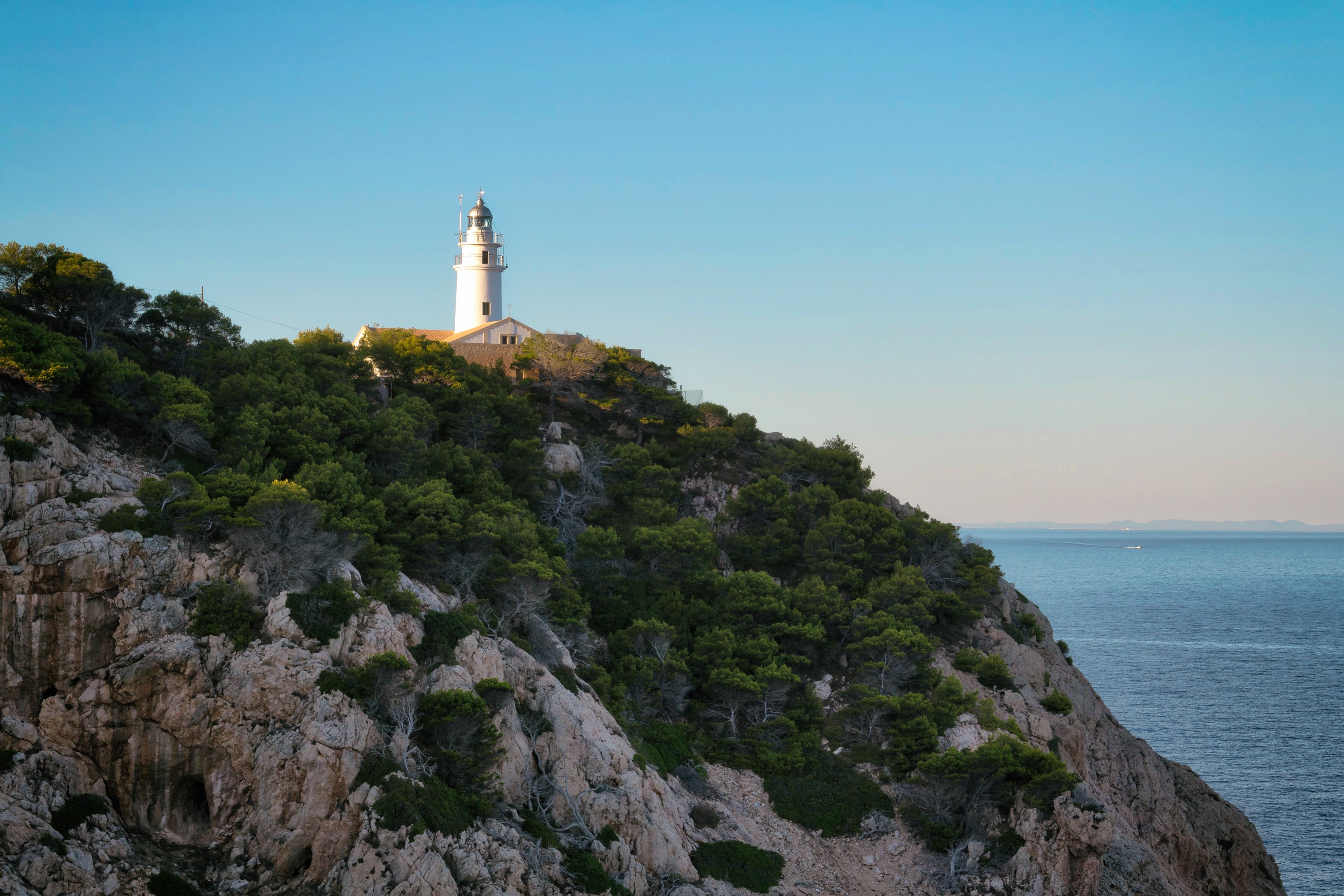 Lighthouse on a rocky cliff overlooking the Mediterranean Sea HD Wallpaper