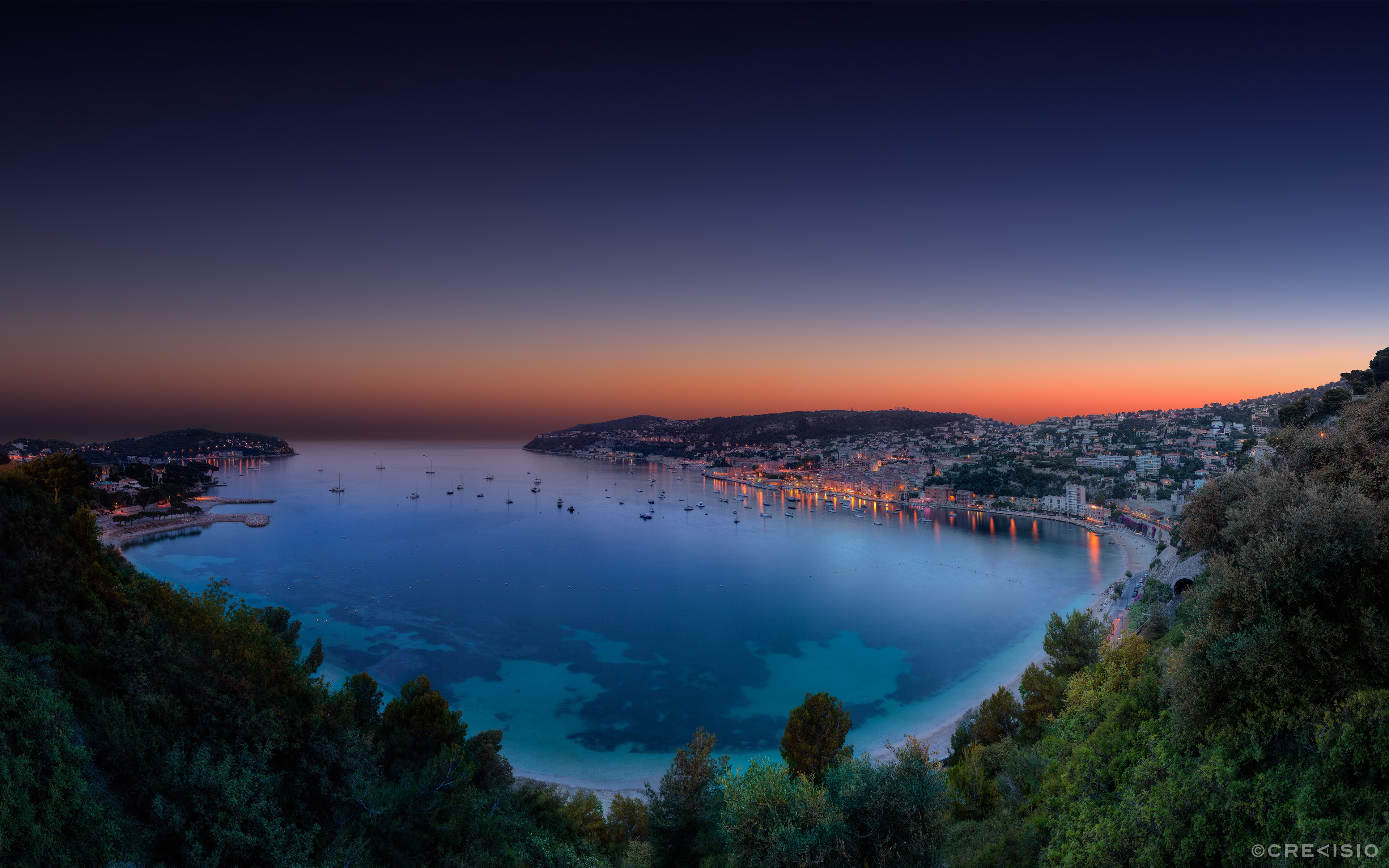 Coastal town and bay at dusk HD Wallpaper