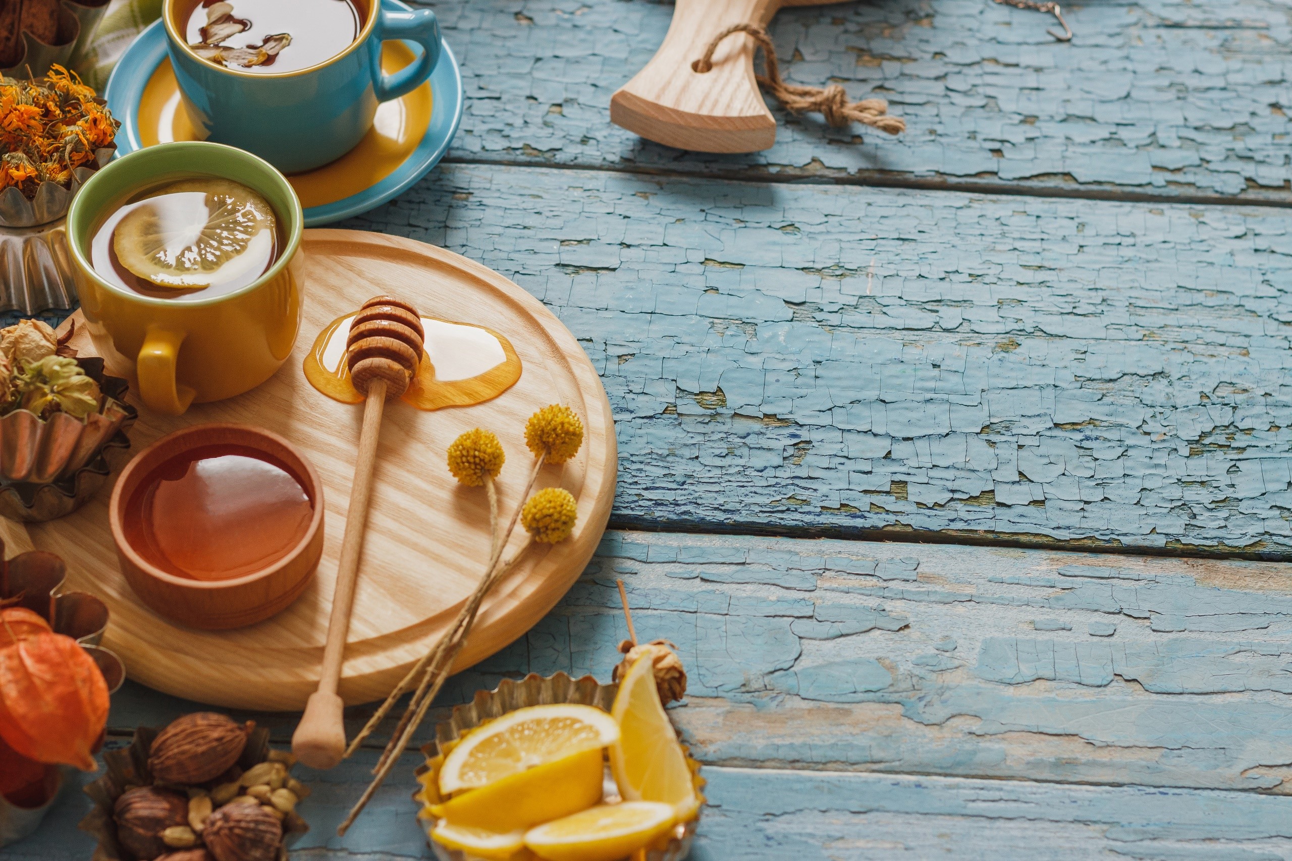 Tea, honey, and lemon on a wooden surface HD Wallpaper