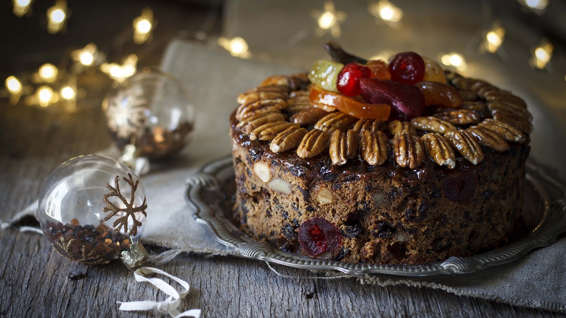 Christmas fruitcake decorated with pecans and candied fruit HD Wallpaper