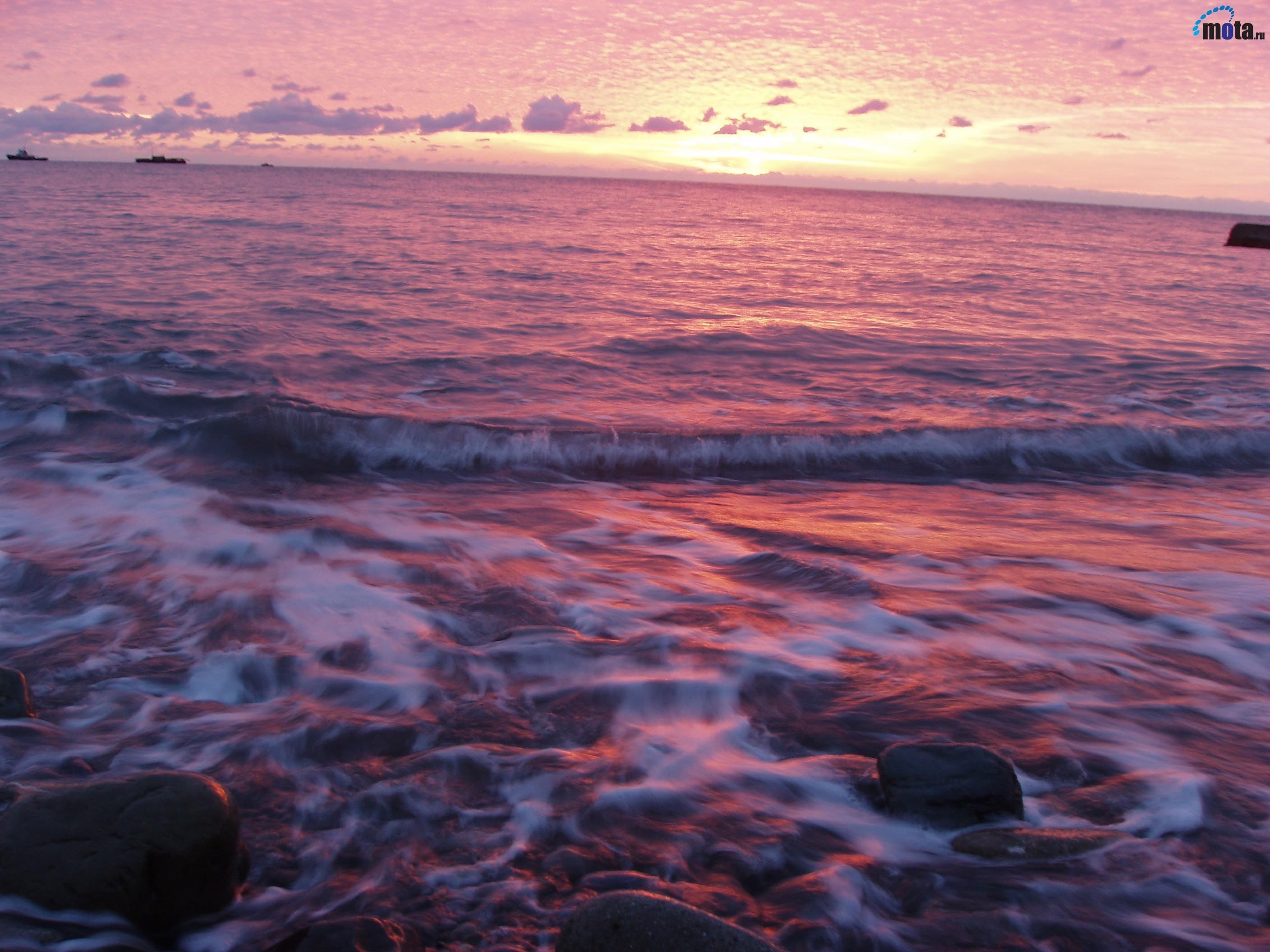 Pink sunset over the ocean with waves and ships HD Wallpaper